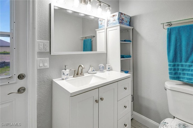 bathroom featuring vanity and toilet