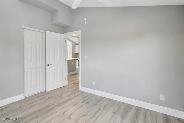 unfurnished bedroom featuring light hardwood / wood-style floors and a closet