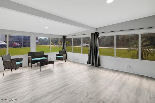 sunroom / solarium featuring beam ceiling