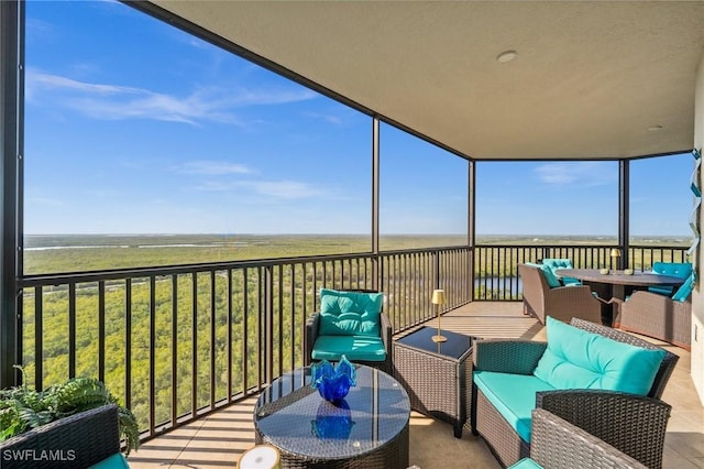 exterior space featuring a water view and an outdoor living space