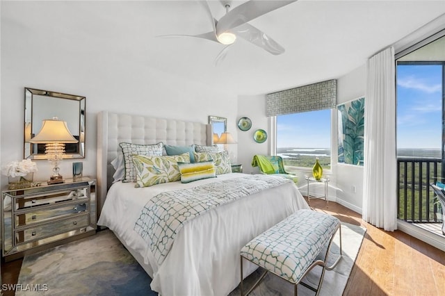 bedroom with access to exterior, dark wood-style floors, baseboards, and a ceiling fan