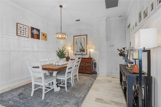 dining area with ornamental molding, dark hardwood / wood-style floors, and a notable chandelier