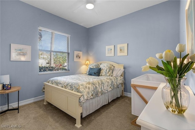 bedroom with light carpet and ceiling fan