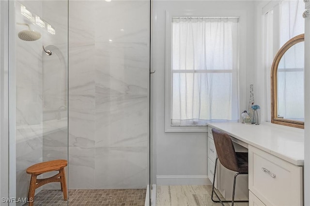 bathroom with a healthy amount of sunlight and tiled shower