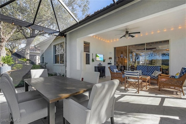 view of patio / terrace with ceiling fan, an outdoor living space, and a lanai