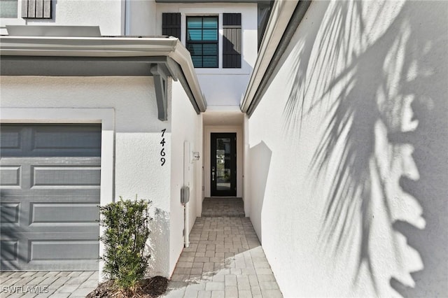 doorway to property featuring a garage