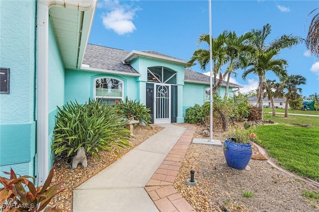 entrance to property with a lawn