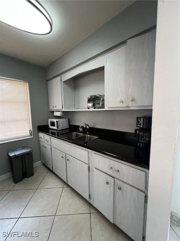 kitchen featuring light tile patterned flooring and sink