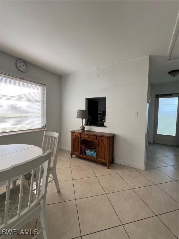 interior space with light tile patterned floors and plenty of natural light