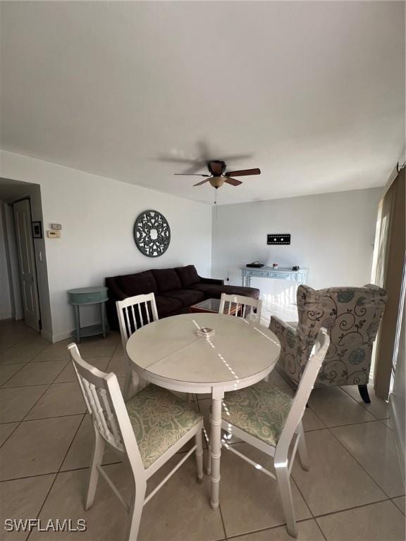 tiled dining space with ceiling fan