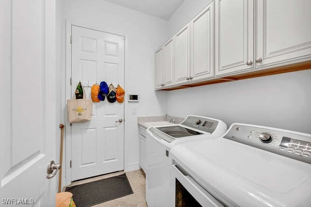 laundry area with cabinets and washer and clothes dryer