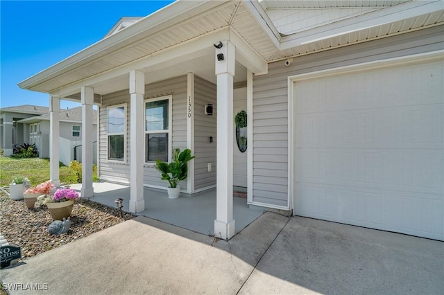 entrance to property featuring a porch and a garage