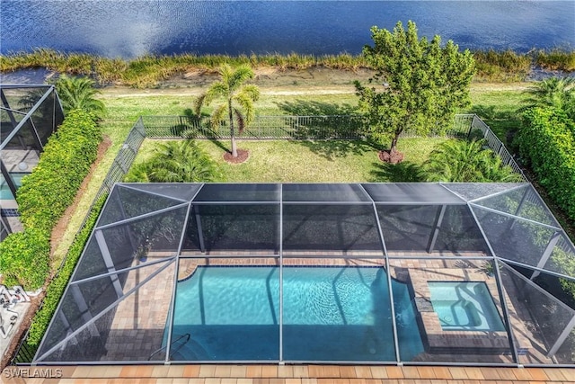 view of swimming pool featuring a lanai, a fenced backyard, and a water view