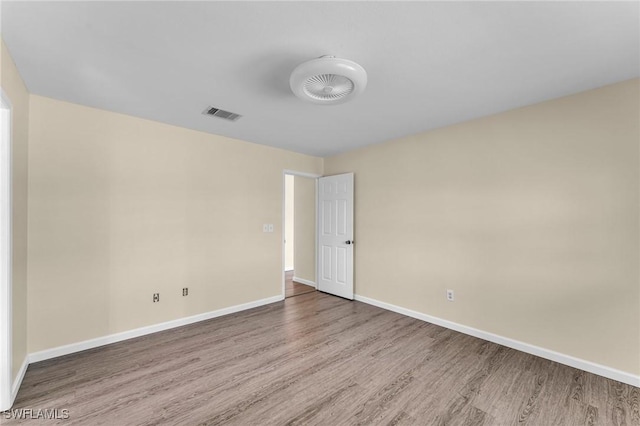 spare room with wood-type flooring