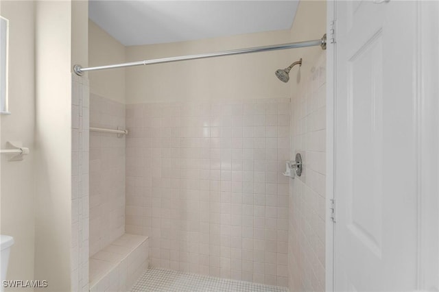 bathroom with tiled shower