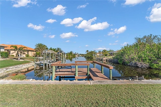 dock area with a yard and a water view