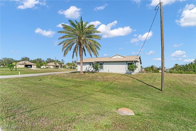 ranch-style home with a front lawn