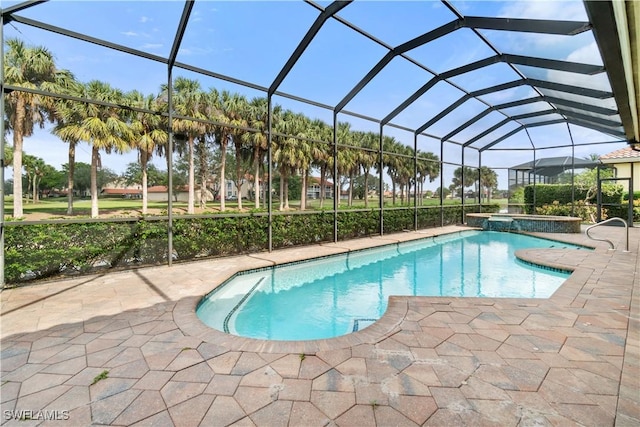 view of pool featuring a lanai, a patio, and a pool with connected hot tub