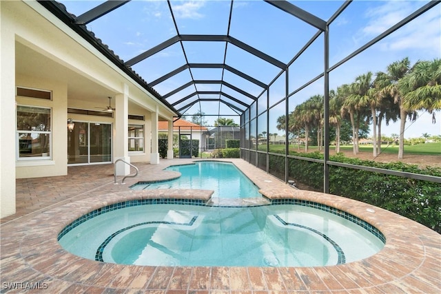 view of swimming pool with a patio area, glass enclosure, and a pool with connected hot tub