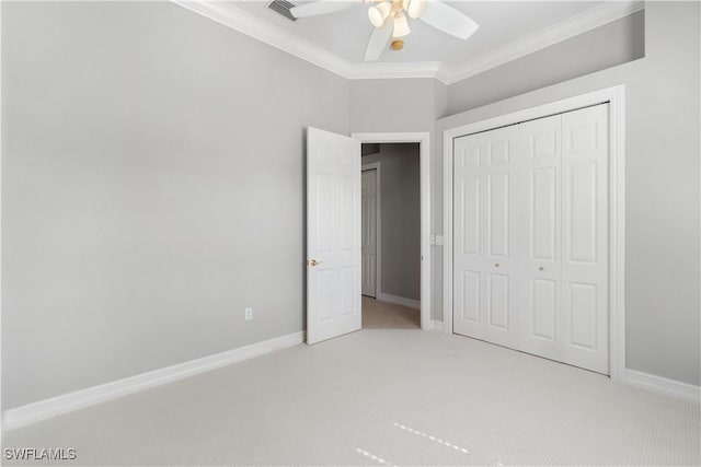 unfurnished bedroom with baseboards, visible vents, light carpet, and crown molding