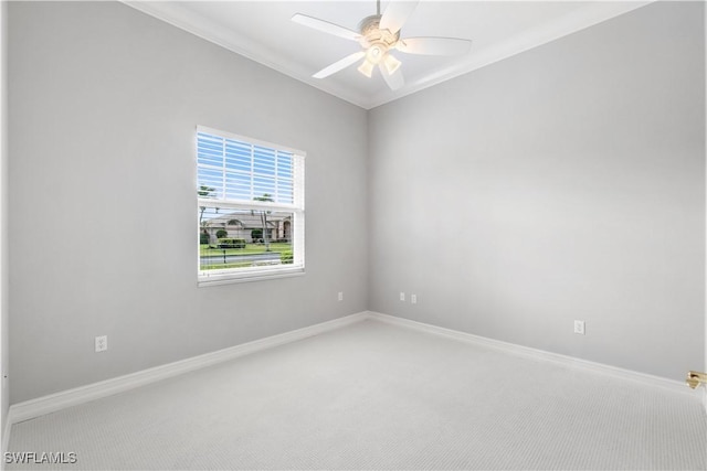 empty room featuring baseboards, ceiling fan, carpet flooring, and ornamental molding