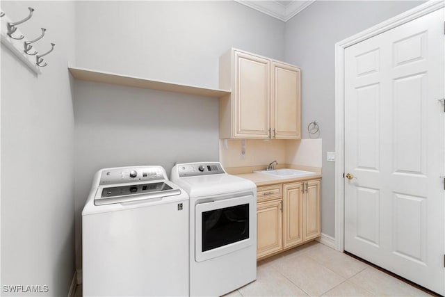 laundry room featuring a sink, crown molding, washer and dryer, light tile patterned flooring, and cabinet space