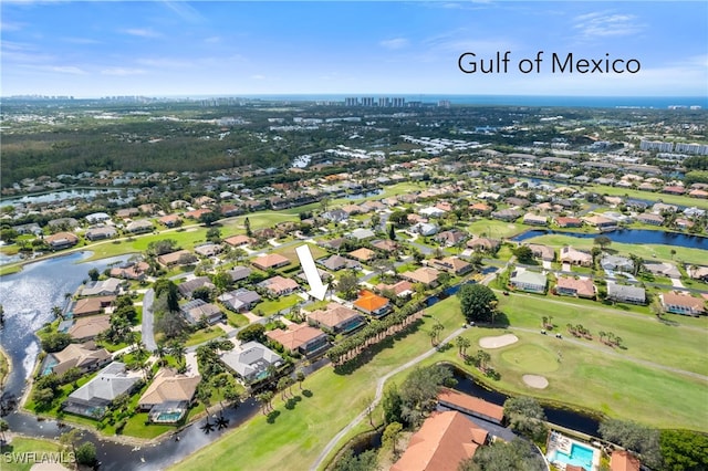 birds eye view of property with a residential view, view of golf course, and a water view