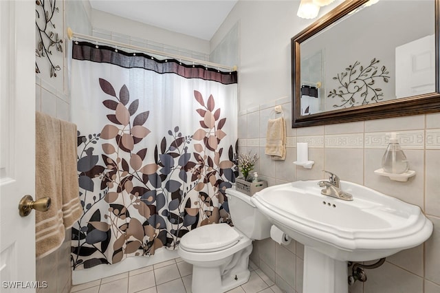 bathroom with sink, tile walls, tile patterned flooring, curtained shower, and toilet