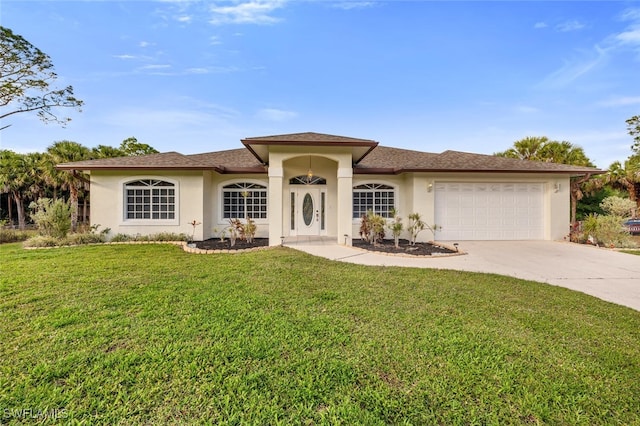 view of front of home featuring a garage and a front lawn