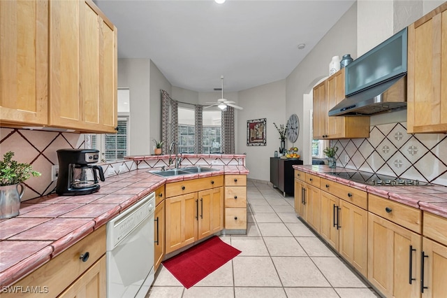 kitchen with sink, tile countertops, light tile patterned floors, black electric cooktop, and white dishwasher