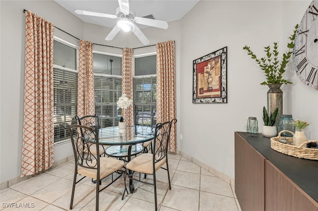 dining area with light tile patterned floors and ceiling fan