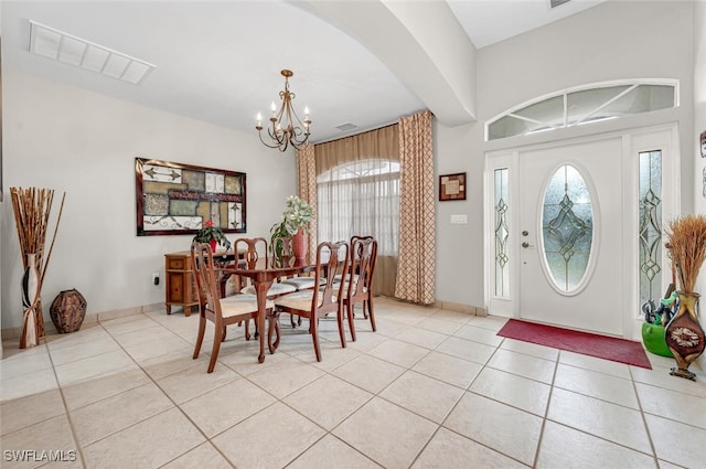 entryway featuring light tile patterned floors and a chandelier