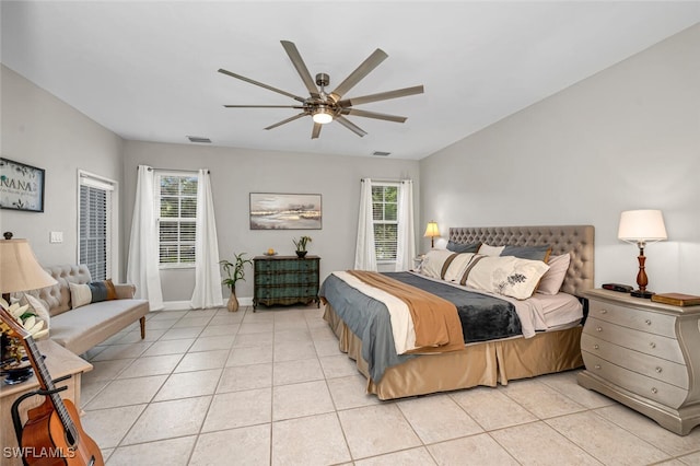 bedroom with light tile patterned flooring, ceiling fan, and multiple windows