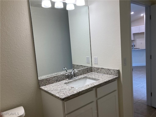 bathroom with tile patterned floors, vanity, and toilet