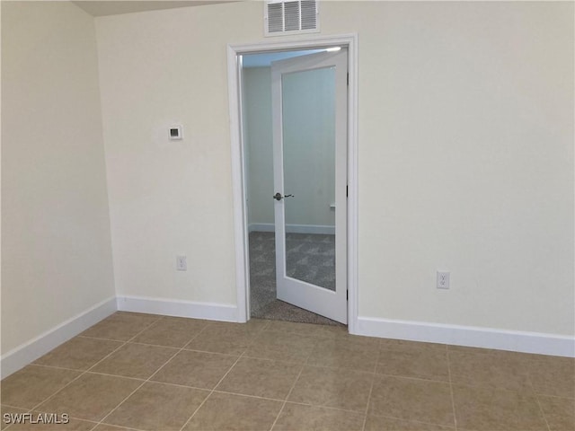 spare room featuring light tile patterned floors