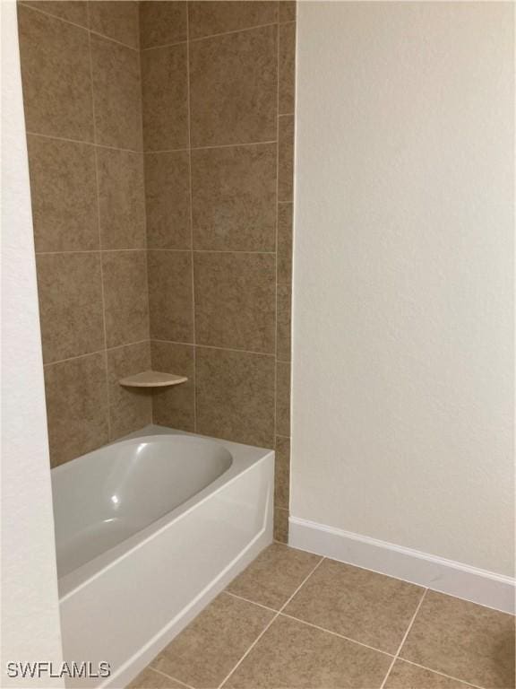 bathroom with tile patterned floors and tiled shower / bath combo