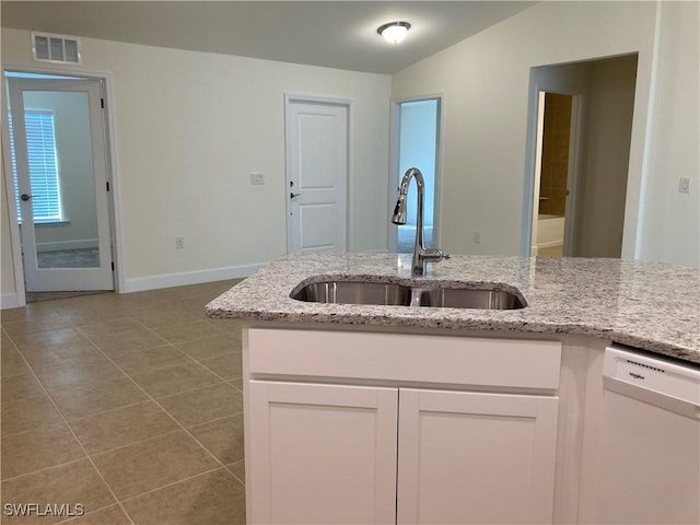 kitchen featuring white dishwasher, sink, white cabinetry, and light stone counters