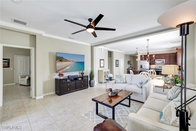 14558 Manchester Dr, Naples, FL 34114 - living room featuring crown molding, ceiling fan with notable chandelier, and light tile patterned floors