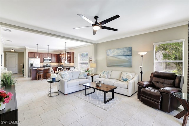 14558 Manchester Dr, Naples, FL 34114 - tiled living room with ceiling fan with notable chandelier and ornamental molding