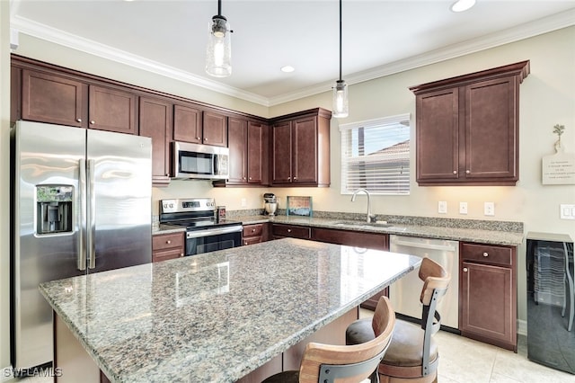 14558 Manchester Dr, Naples, FL 34114 - kitchen featuring pendant lighting, sink, appliances with stainless steel finishes, light stone countertops, and a kitchen island