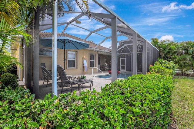 14558 Manchester Dr, Naples, FL 34114 - rear view of property featuring a lanai and a patio area
