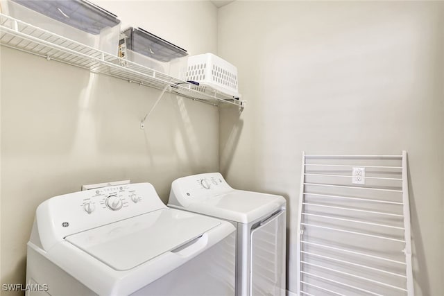 14558 Manchester Dr, Naples, FL 34114 - clothes washing area featuring washing machine and clothes dryer