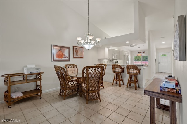 tiled dining space with a chandelier and high vaulted ceiling