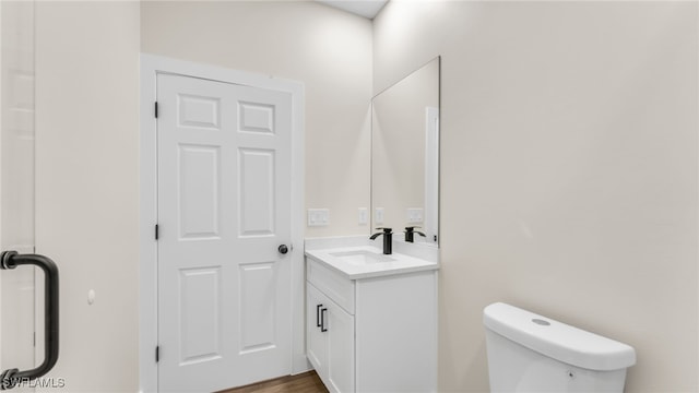 bathroom featuring vanity and toilet