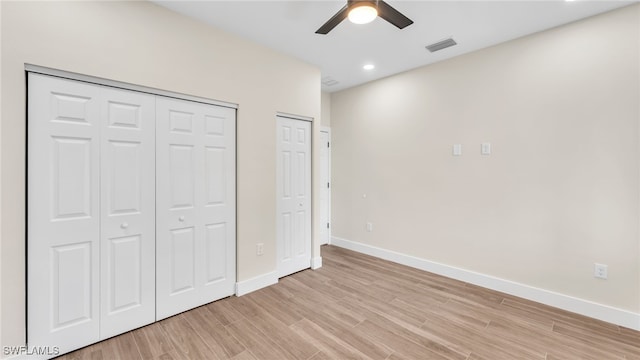 unfurnished bedroom with ceiling fan and light hardwood / wood-style floors