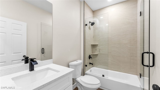 full bathroom with vanity, shower / bath combination with glass door, and toilet