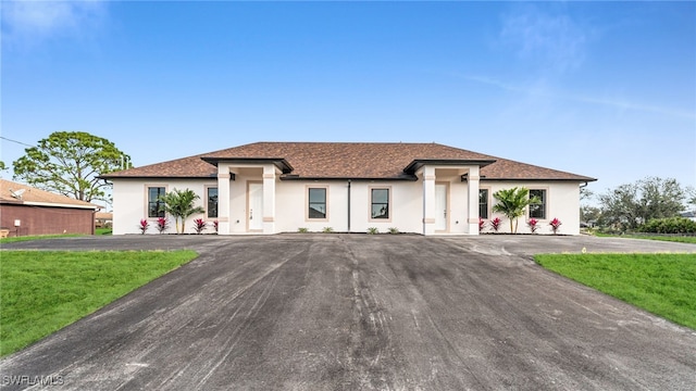 view of front of home featuring aphalt driveway and stucco siding