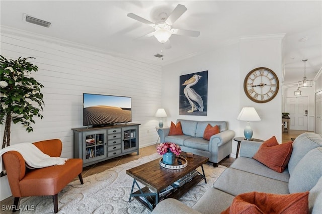 living room featuring ornamental molding and ceiling fan