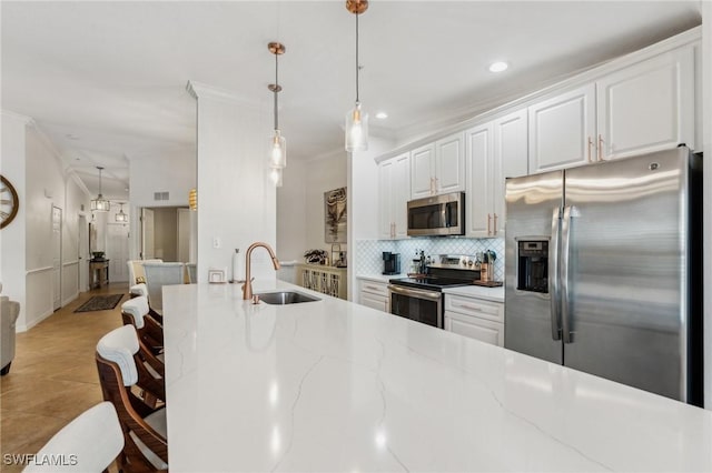 9517 Avellino Way Unit 2224, Naples, FL 34113 - kitchen with stainless steel appliances, a sink, backsplash, crown molding, and white cabinetry