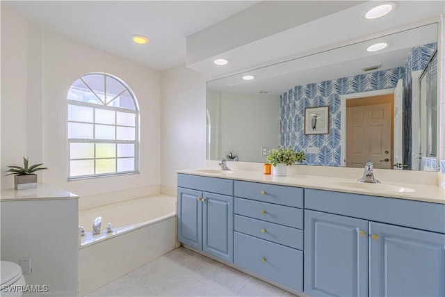 bathroom with double vanity, wallpapered walls, a garden tub, and a sink